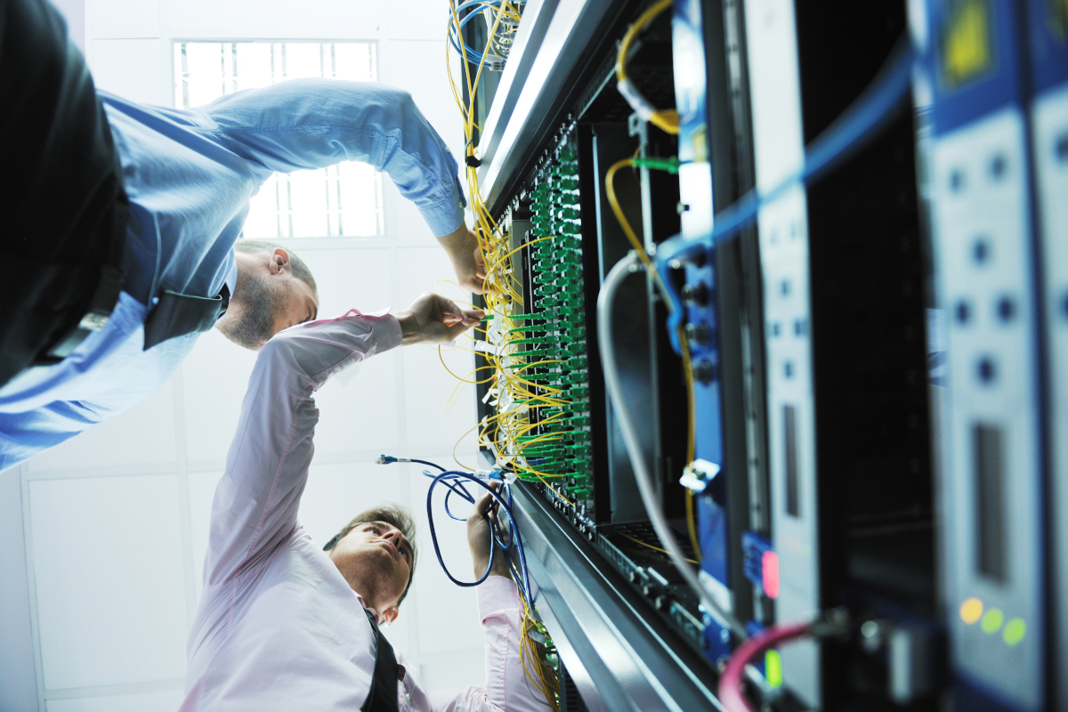 Two men working in server room